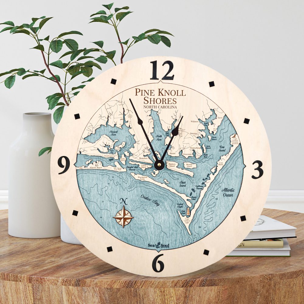 Pine Knoll Shores Nautical Wall Clock Birch Accent with Blue Green Water Sitting on Coffee Table by Books and Vases