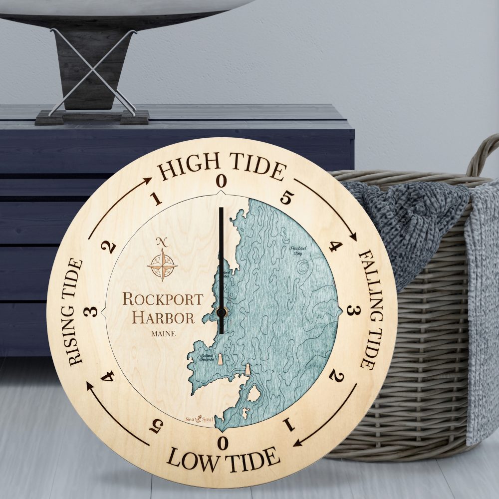 Rockport Harbor Tide Clock Birch Accent with Blue Green Water Sitting on Ground by Basket