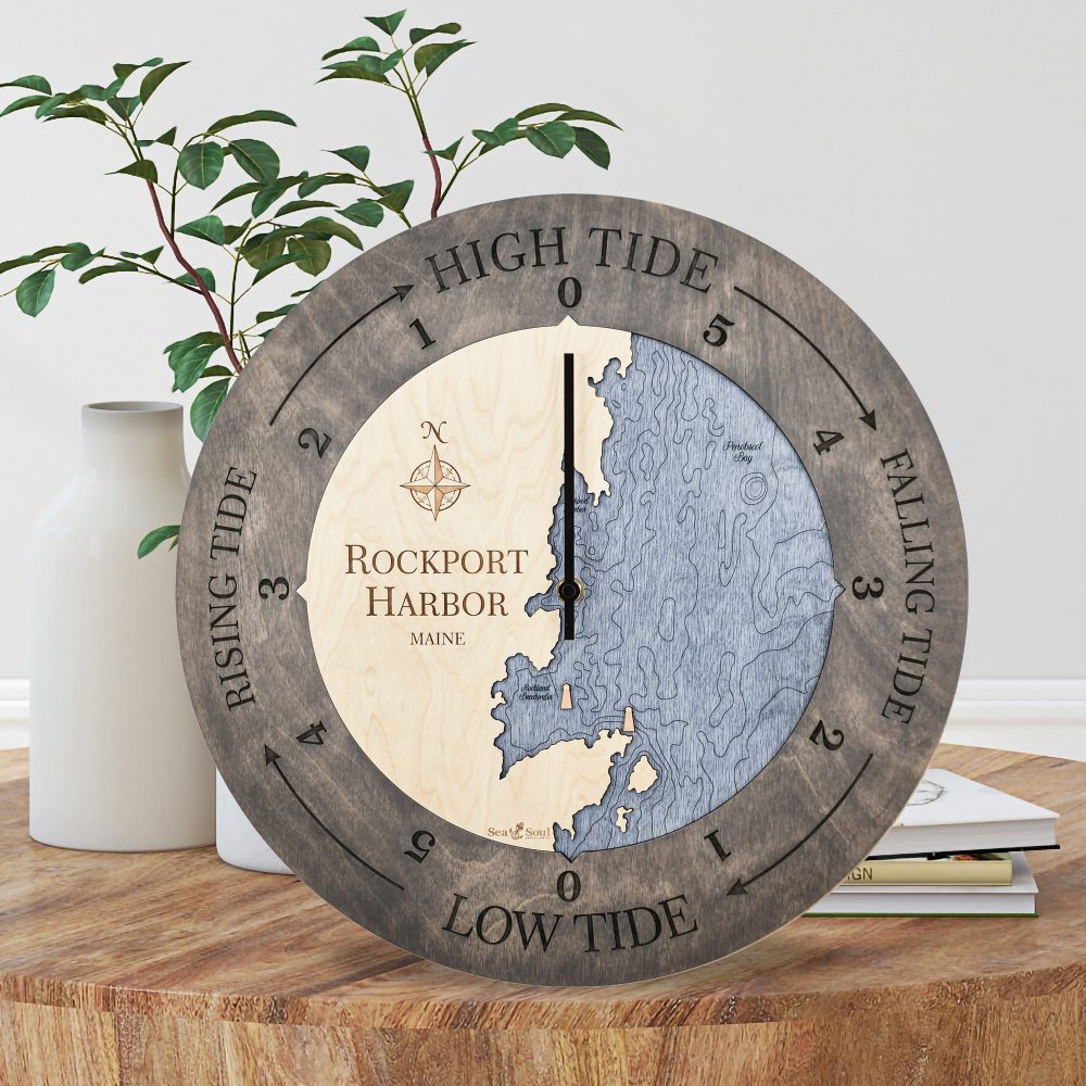 Rockport Harbor Tide Clock Driftwood Accent with Deep Blue Water Sitting on Coffee Table by Books and Vases