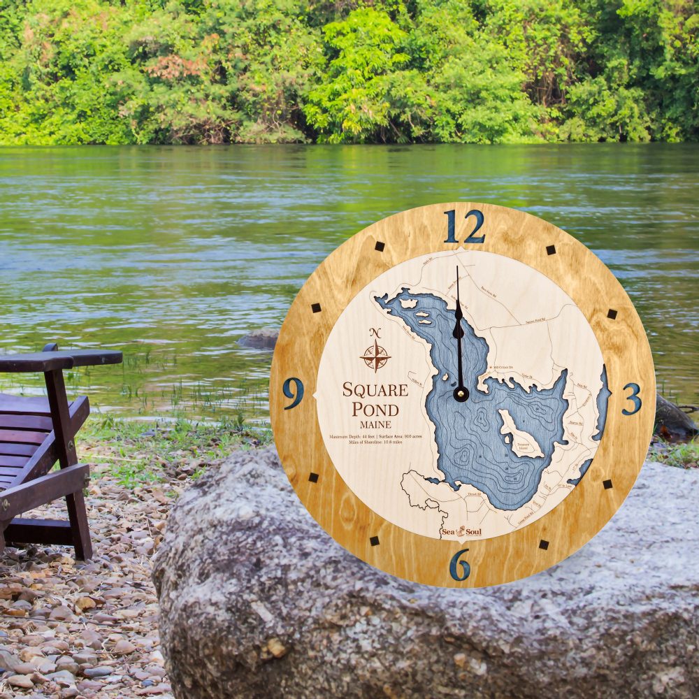Square Pond Nautical Clock Honey Accent with Deep Blue Water Sitting on Rock by Water