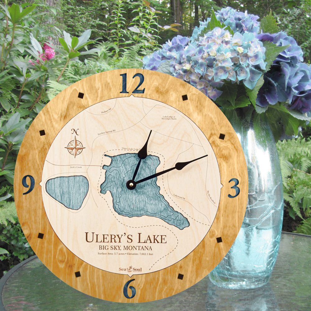Ulery's Lake Nautical Clock Honey Accent with Blue Green Water Sitting on Outdoor Table by Flowers