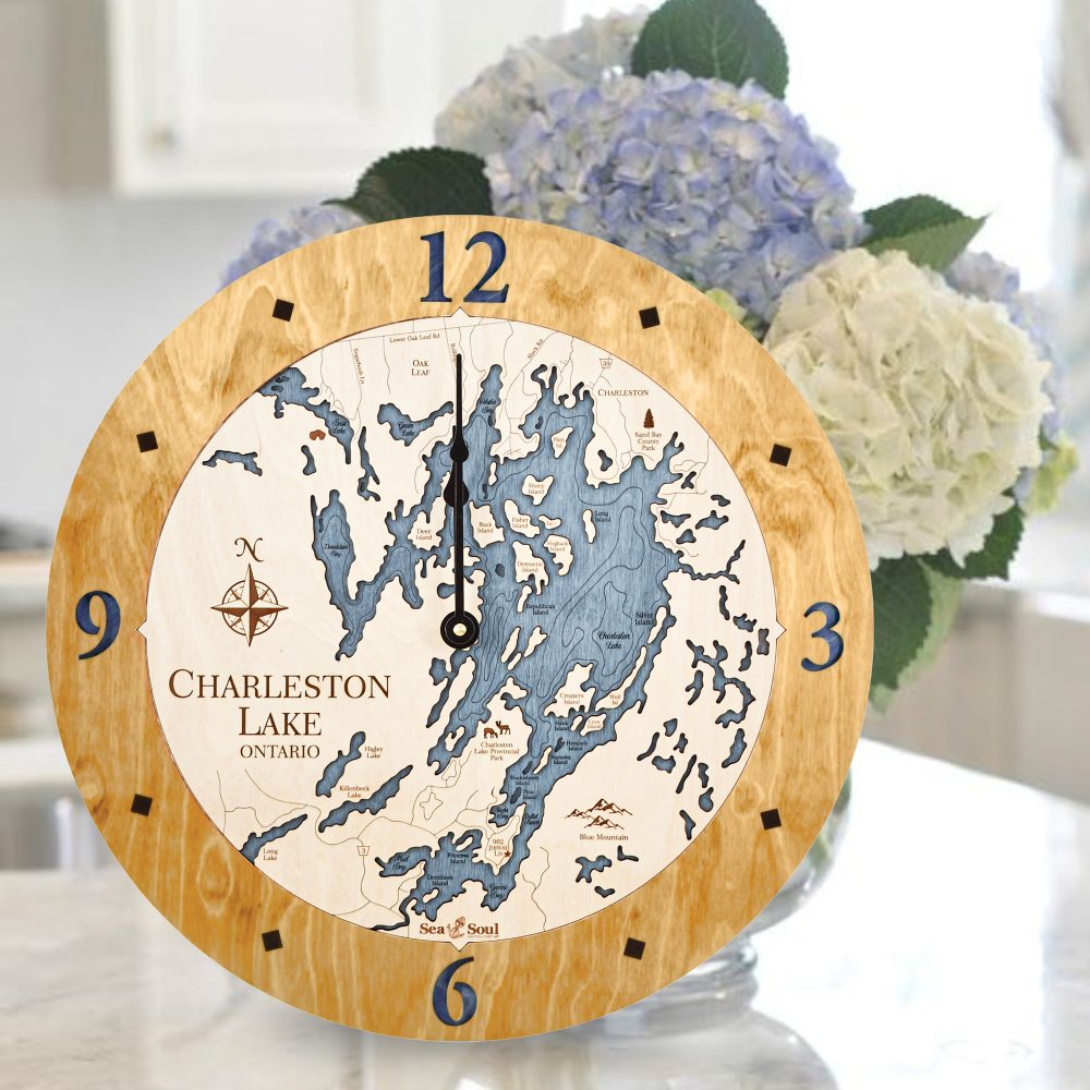 Charleston Lake Nautical Clock Honey Accent with Deep Blue Water Sitting on Countertop by Flowers