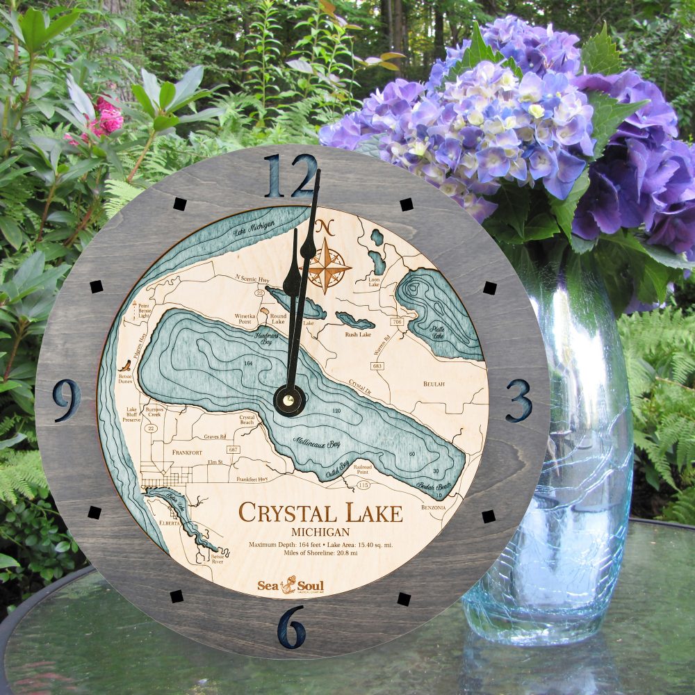 Crystal Lake Nautical Clock Driftwood Accent with Blue Green Water Sitting on Outdoor Table by Flowers