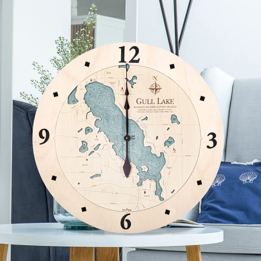 Gull Lake Nautical Clock Birch Accent with Blue Green Water Sitting on Coffee Table by Armchair