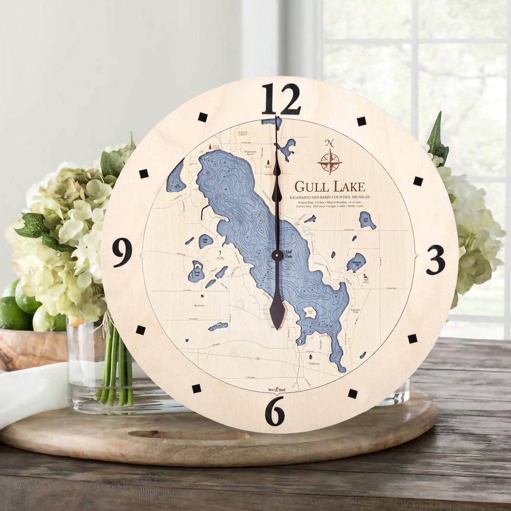 Gull Lake Nautical Clock Birch Accent with Deep Blue Water Sitting on Table by Flowers