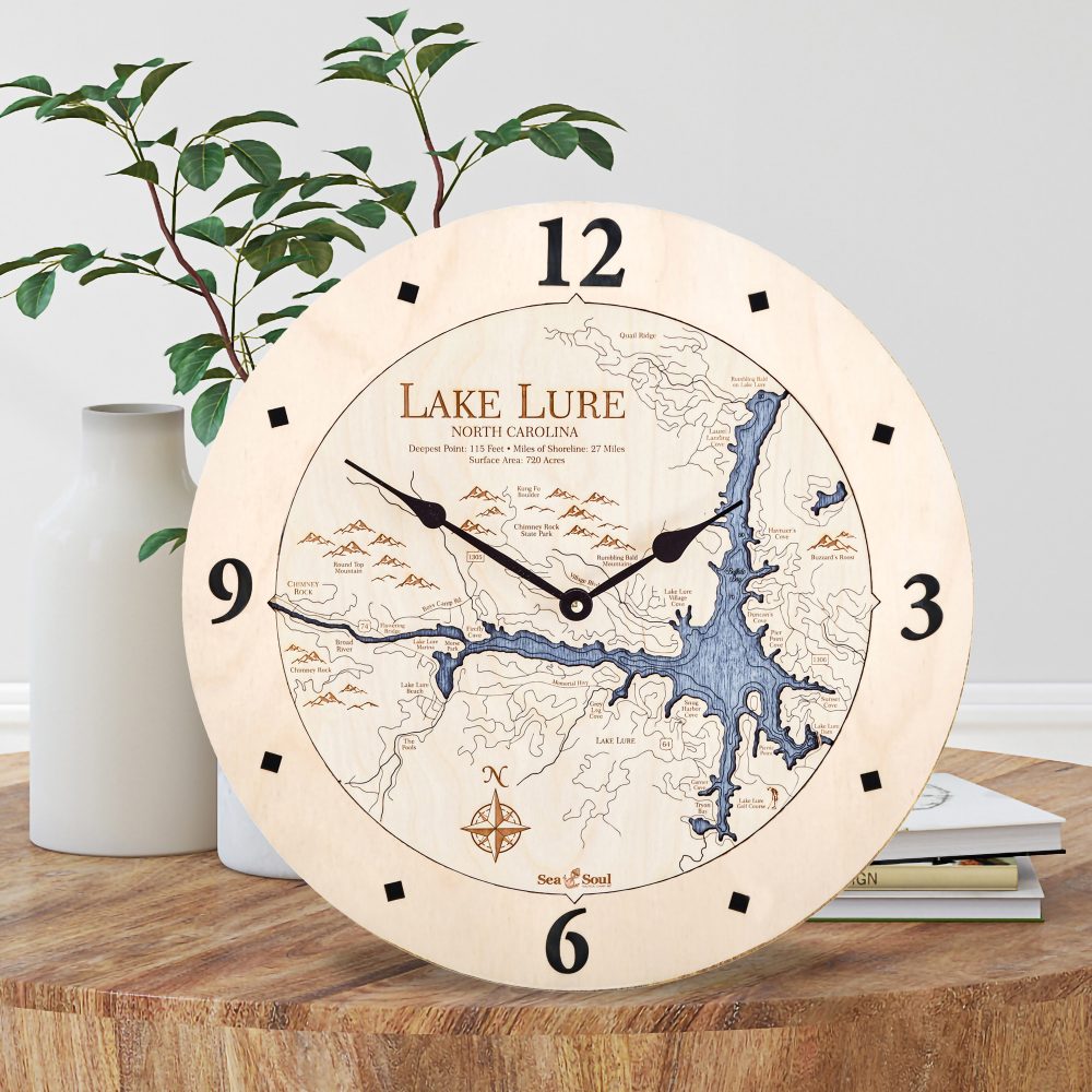 Lake Lure Nautical Clock Birch Accent with Deep Blue Water Sitting on Coffee Table by Books and Vases