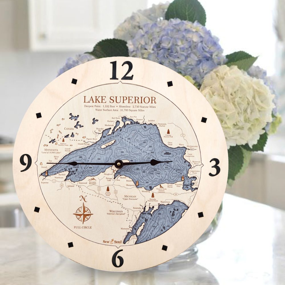 Lake Superior Nautical Clock Birch Accent with Deep Blue Water Sitting on Countertop by Flowers