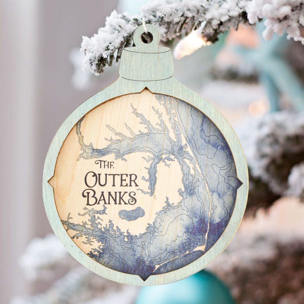 Outer Banks Christmas Ornament Bleach Blue Accent with Deep Blue Water Hanging on Christmas Tree with Snow