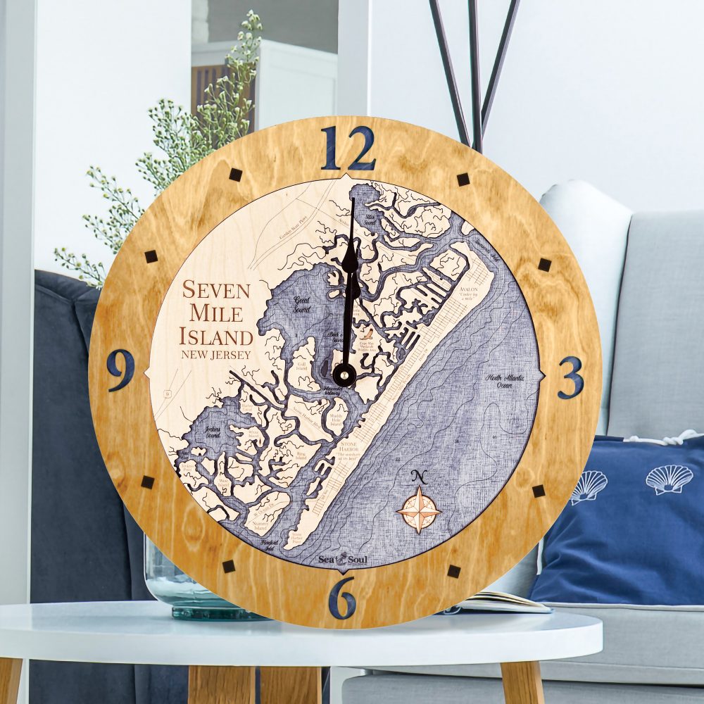 Seven Mile Island Nautical Clock Honey Accent with Deep Blue Water Sitting on Coffee Table by Armchair