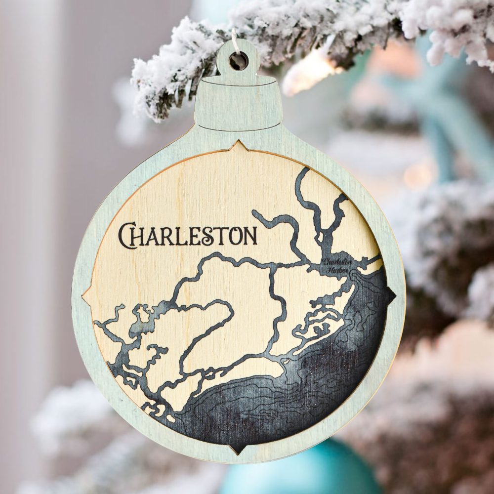Charleston Christmas Ornament Bleach Blue Accent with Deep Blue Water Hanging on Outdoor Pine Tree with Snow