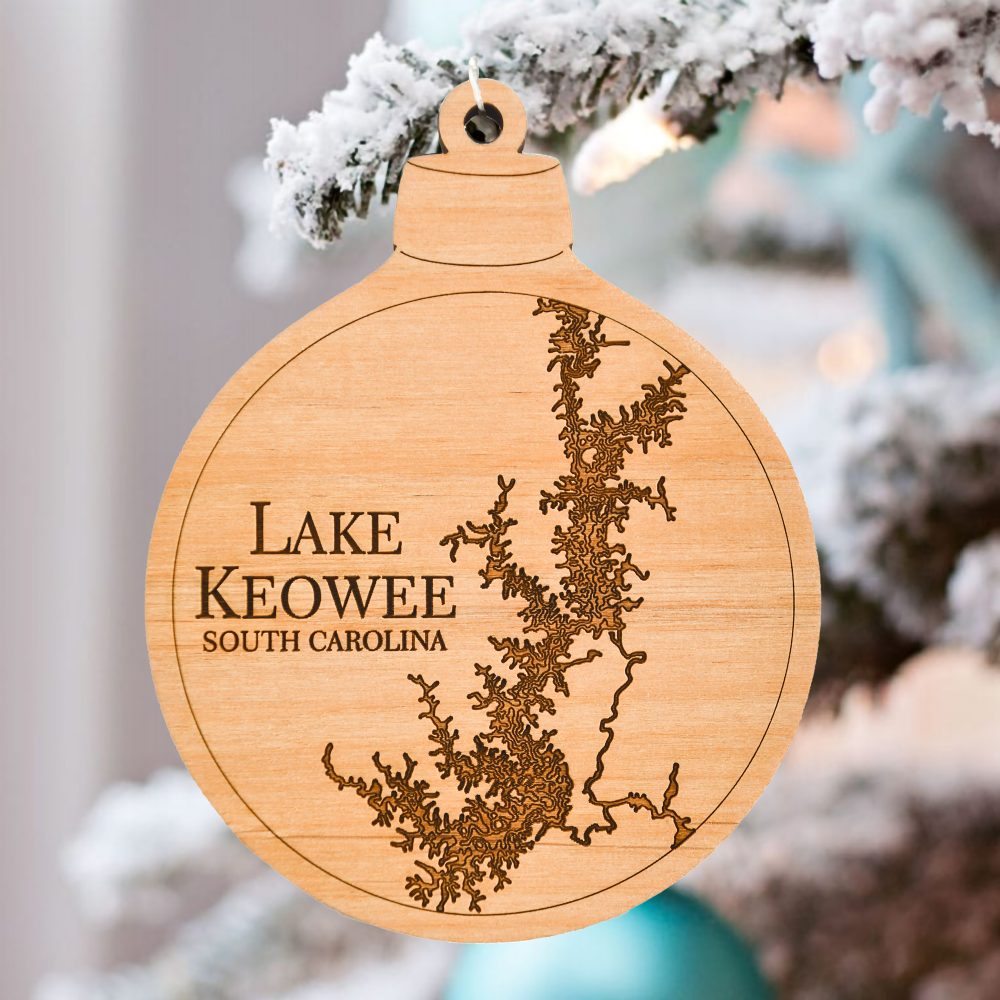 Lake Keowee Engraved Nautical Ornament Hanging on Pine Tree Outdoors with Snow