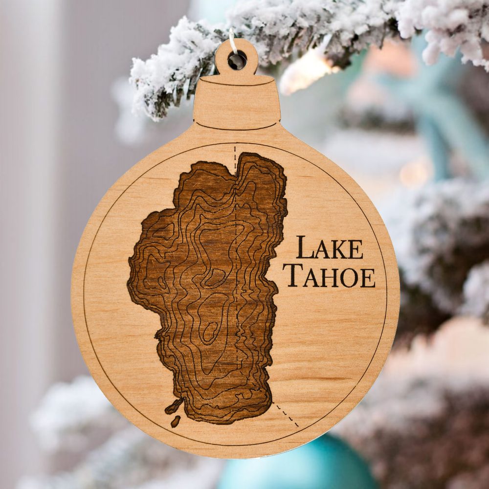 Lake Tahoe Engraved Ornament Hanging on Pine Tree Outdoors with Snow