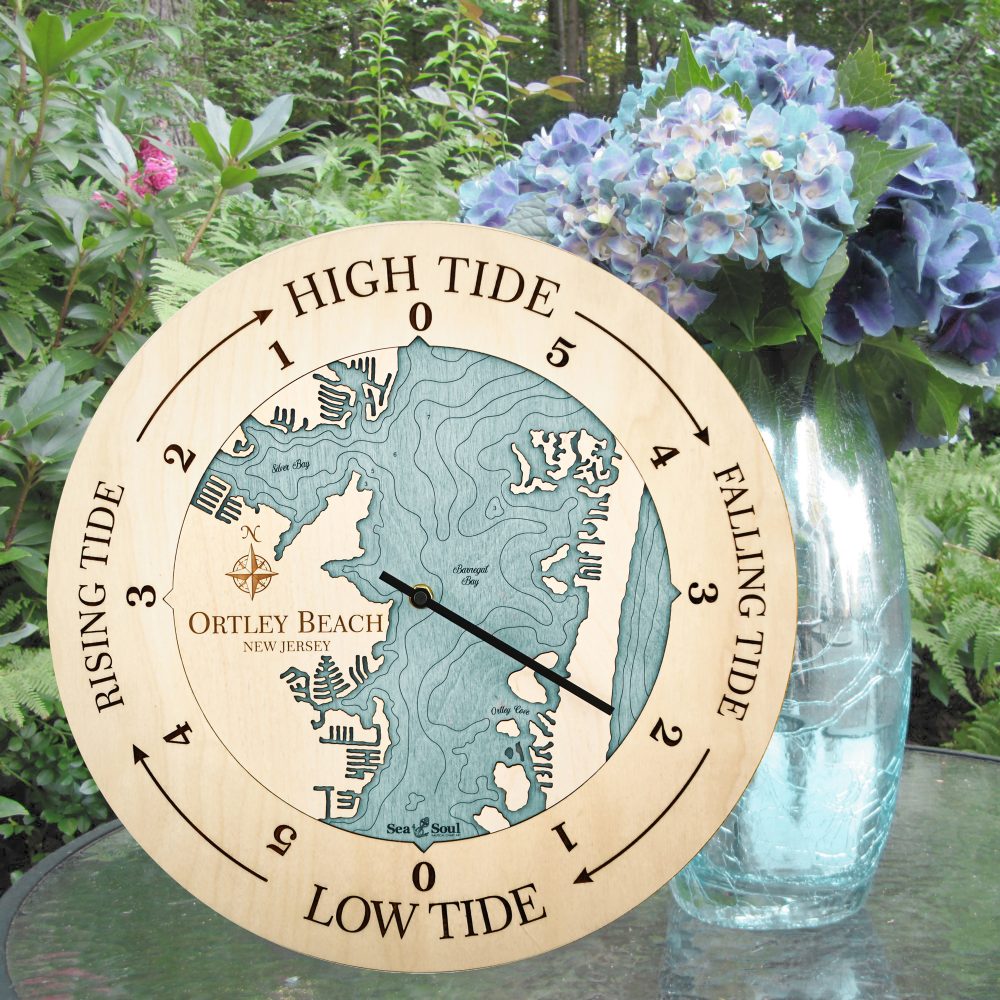 Ortley Beach Tide Clock Birch Accent with Blue Green Water Sitting on Outdoor Table with Flowers