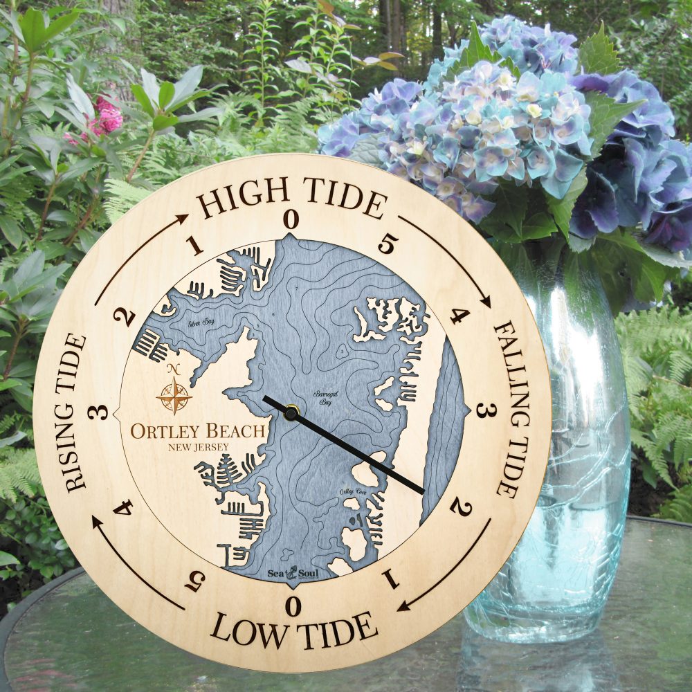 Ortley Beach Tide Clock Birch Accent with Deep Blue Water Sitting on Outdoor Table with Flowers