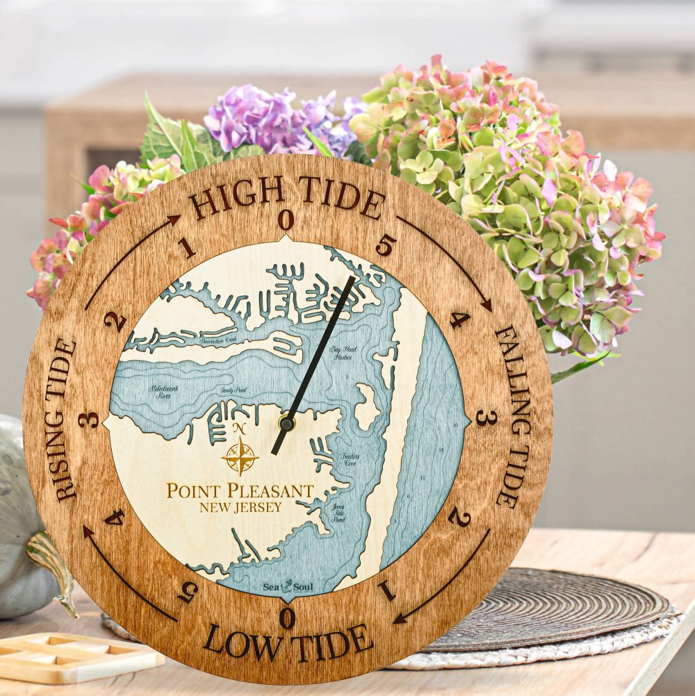 Point Pleasant Tide Clock Americana Accent with Blue Green Water Sitting on Countertop with Flowers