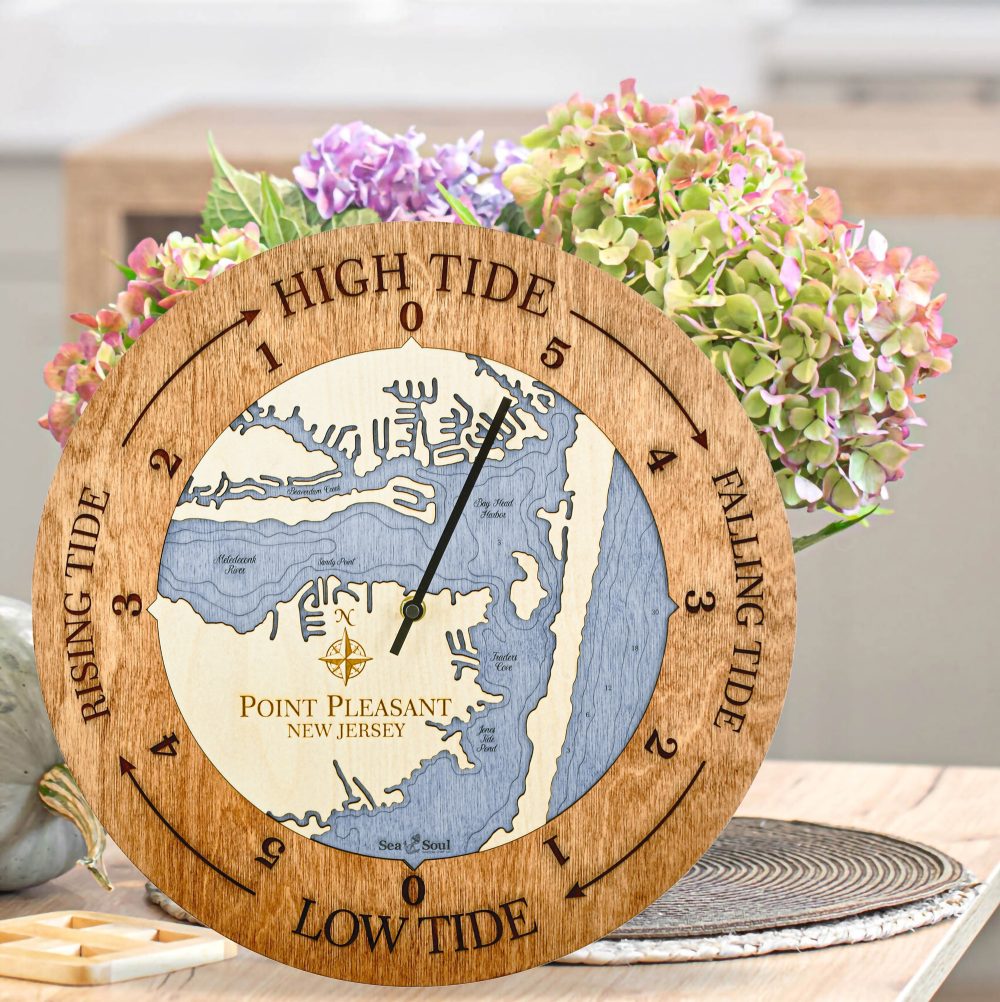 Point Pleasant Tide Clock Americana Accent with Deep Blue Water Sitting on Countertop with Flowers