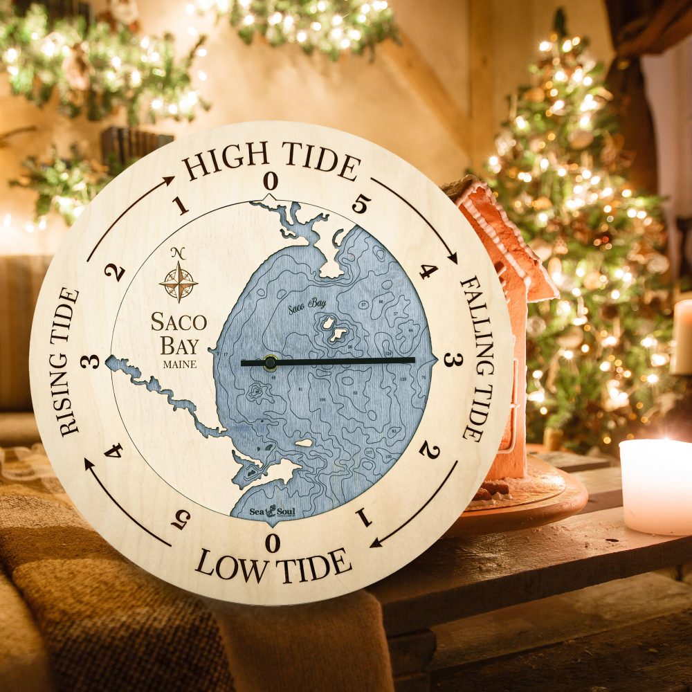 Saco Bay Tide Clock Birch Accent with Deep Blue Water Sitting on Table with Blanket and Gingerbread House