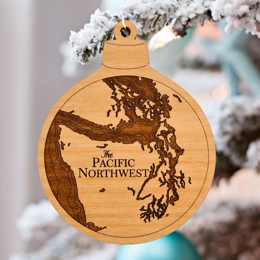 Pacific Northwest Engraved Nautical Ornament Hanging on Outdoor Pine Tree with Snow