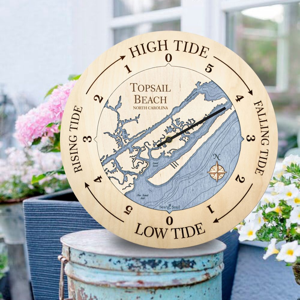 Topsail Beach Tide Clock Birch Accent with Deep Blue Water Sitting on Bucket Outdoors by Flowers