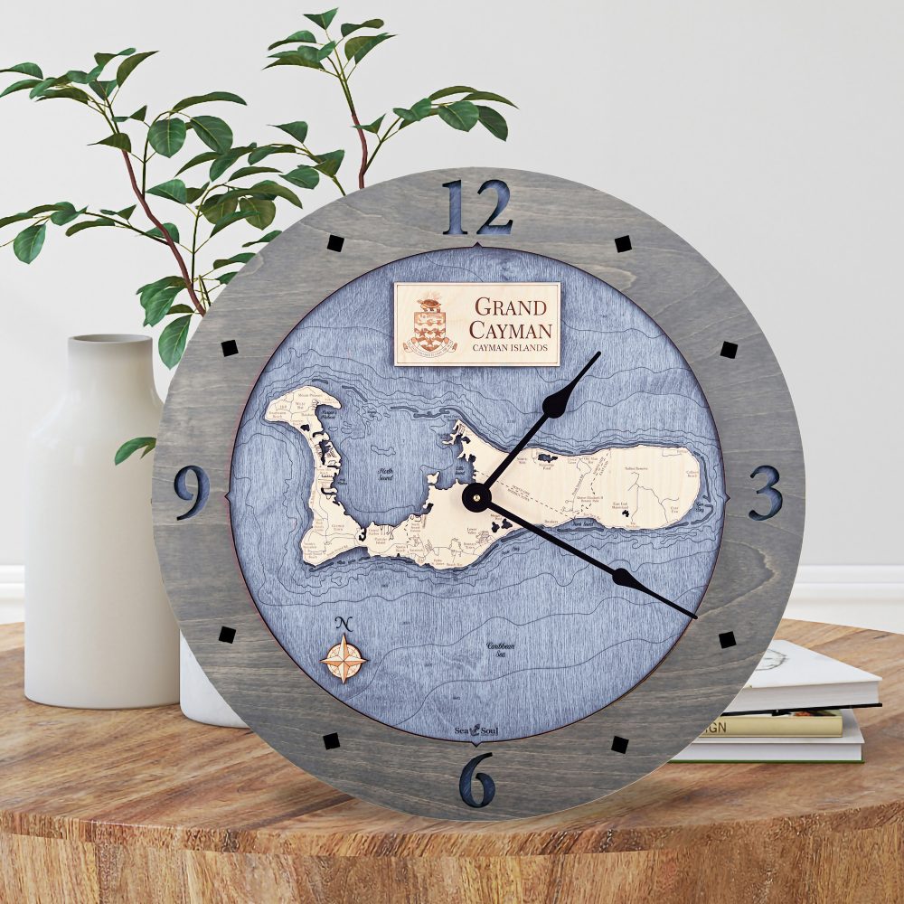 Grand Cayman Nautical Map Clock Driftwood Accent with Deep Blue Water Sitting on Coffee Table by Books and Vases