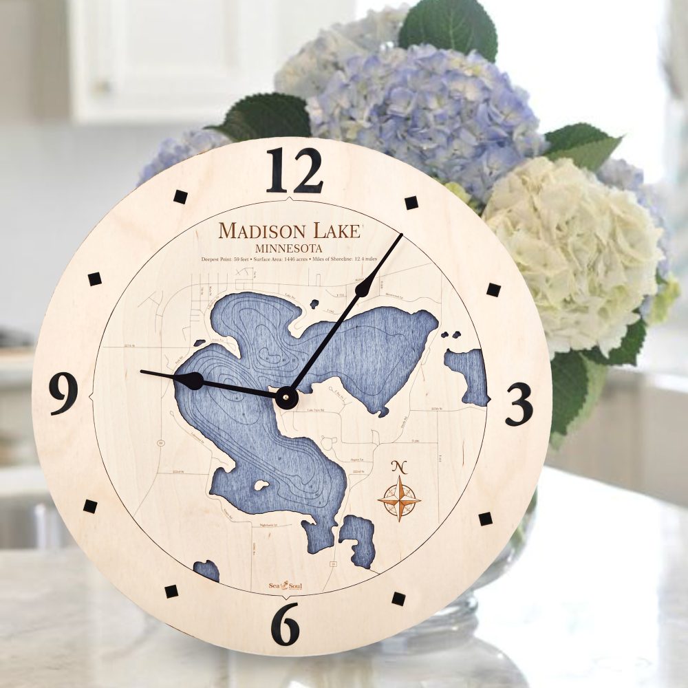 Madison Lake Nautical Map Clock Birch Accent with Deep Blue Water Sitting on Countertop with Flowers